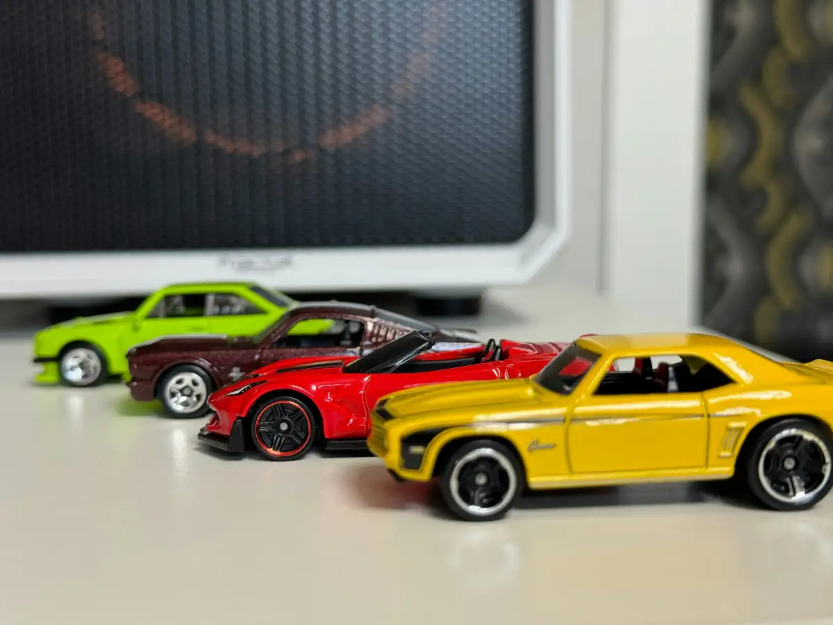 a group of toy cars sitting on top of a desk
